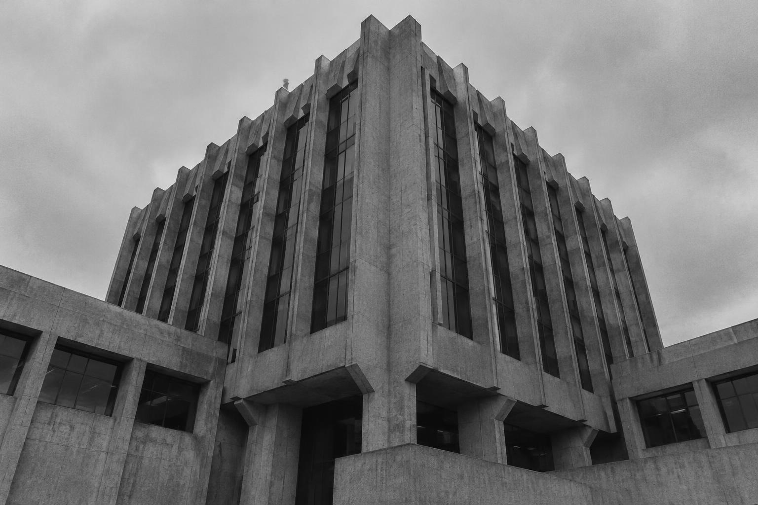 Brutalist corporate headquarters beneath an overcast sky